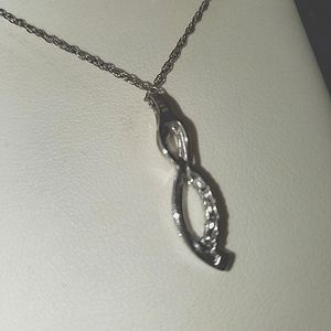 Pendent necklace .with diamonds on it.